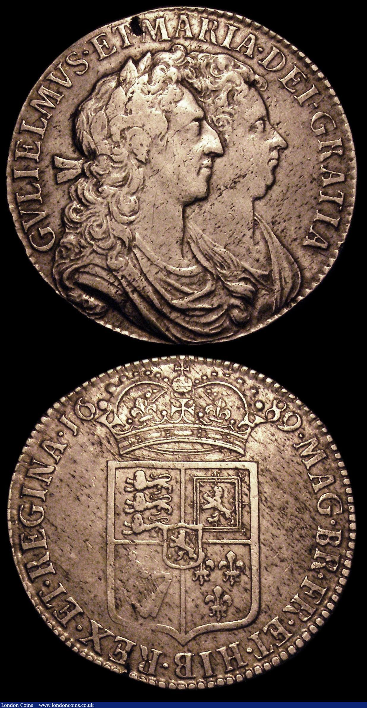 London Coins : A150 : Lot 2445 : Halfcrowns (2) 1689 First Shield, Caul only frosted, with pearls ESC 505 Good Fine with a flan crack...