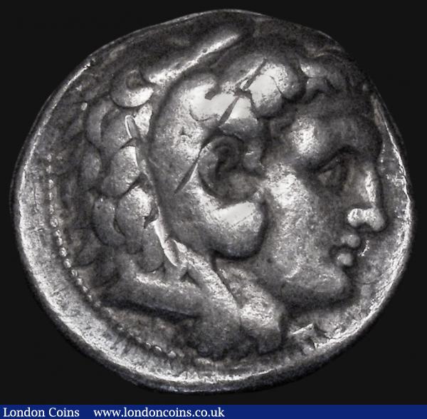 Ancient Greece - Kingdom of Macedonia Tetradrachm Alexander the Great (336-323BC) posthumous issue, Obverse: Head of Heracles wearing Lion-skin right, Reverse: Zeus seated left, monogram within wreath in left field, detail below throne not clear, 16.63 grammes, Fine/Near Fine for wear with a deep vertical scratch on the reverse  : Ancient Coins : Auction 174 : Lot 1052
