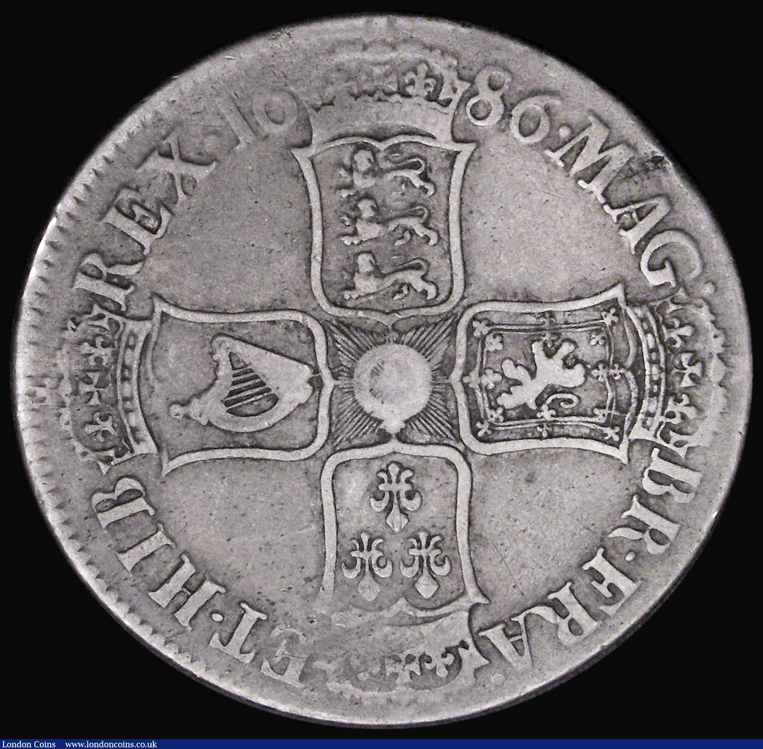 London Coins : A194 : Lot 1083 : Crown 1686 SECVNDO edge ESC 77, Bull 741 Fine, the obverse bold, a small planchet fault by the last ...