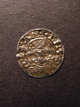 London Coins : A125 : Lot 747 : Penny Cnut, pointed helmet type. Moneyer Leofstan on London. About very fine. Cracked in centre.